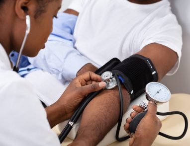 doctor checks blood pressure