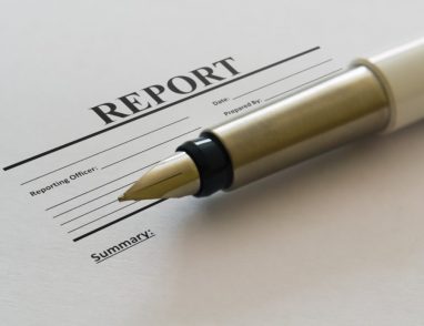 Closeup of a fountain pen and blank report form